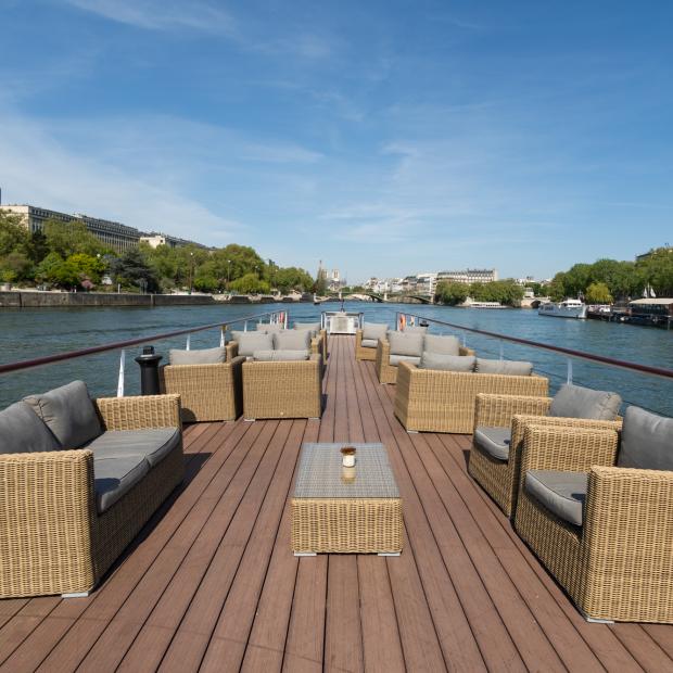 Pont supérieur du bateau Victoria avec salon en rotin sur la Seine à Paris